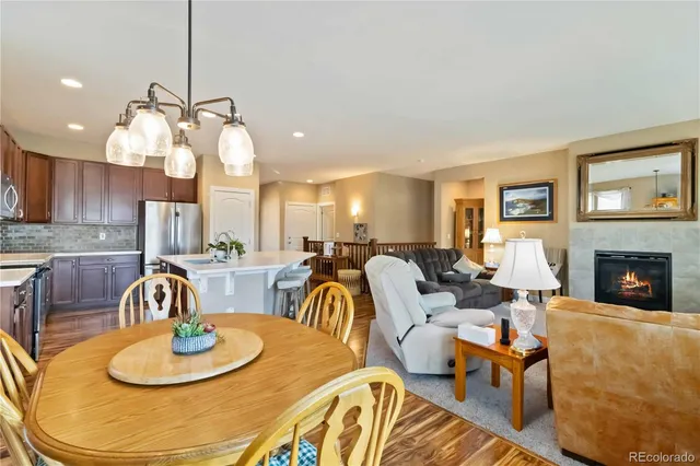 a living room with furniture a mirror and a chandelier