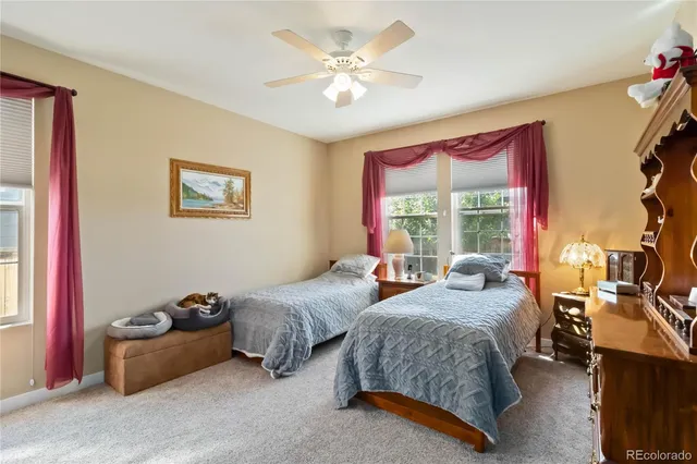a spacious bedroom with two beds and a chandelier