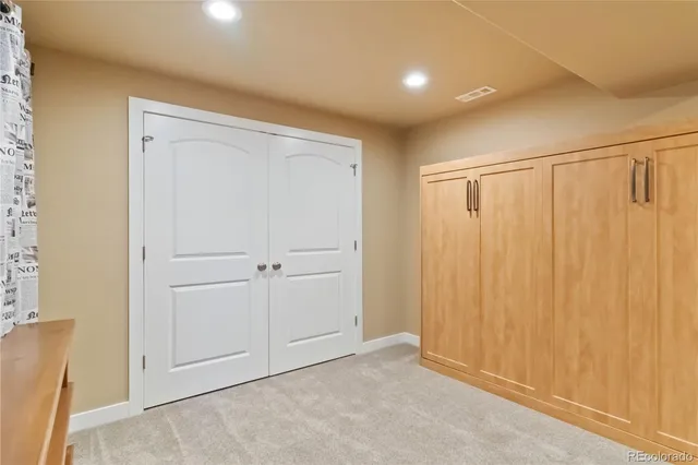 a bathroom with a granite countertop sink mirror vanity and toilet