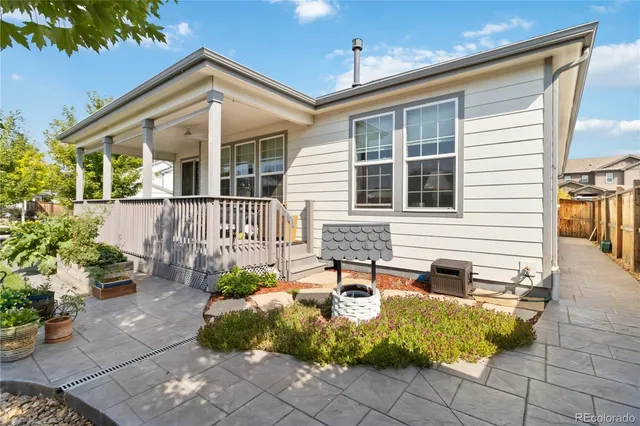 a view of a house with backyard and sitting area