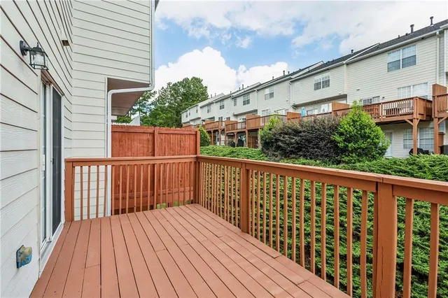 a balcony with wooden floor in front of it