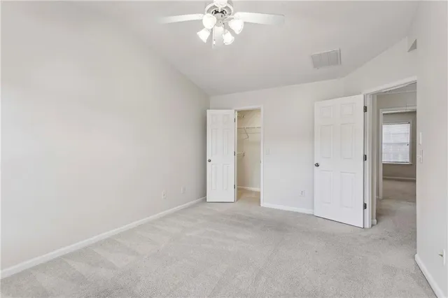a view of an empty room and a bathroom