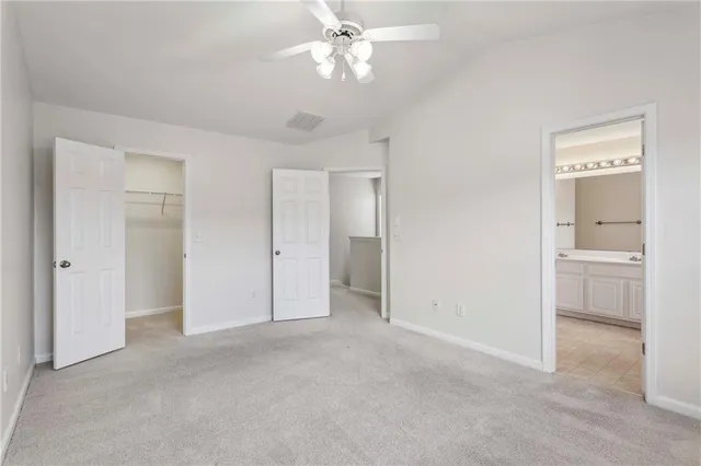 a spacious bathroom with a granite countertop sink and mirror