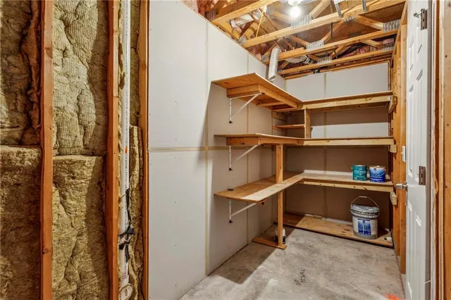 a backyard of a house with plants and outdoor seating