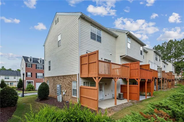 a view of a house with swimming pool and sitting area