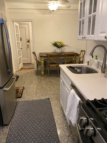 a kitchen with stainless steel appliances granite countertop a refrigerator sink and cabinets