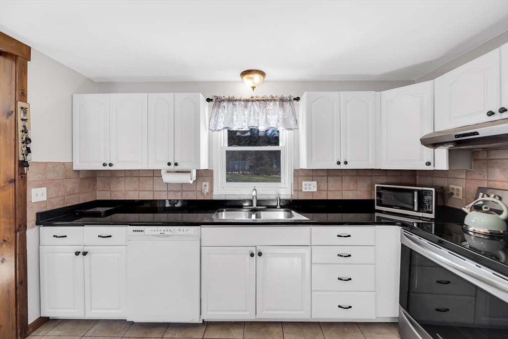 21 Martin Farms Road Hampden, MA 01036 - Photo 9 of 42 a kitchen with granite countertop a white cabinets and a stove