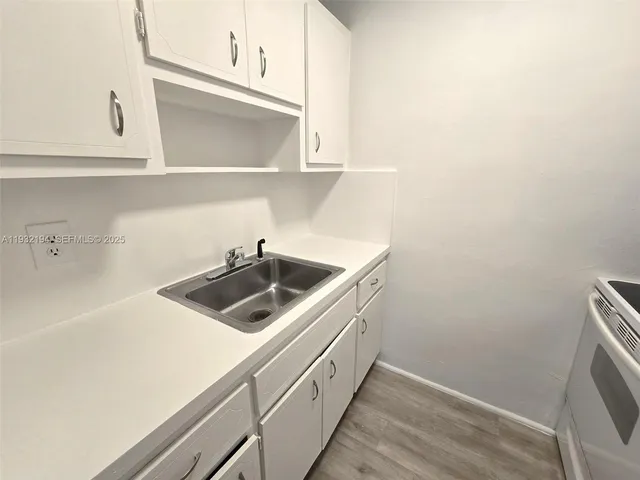 a view of a kitchen with sink and washer