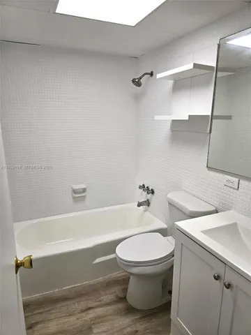 a bathroom with a toilet a sink and bathtub