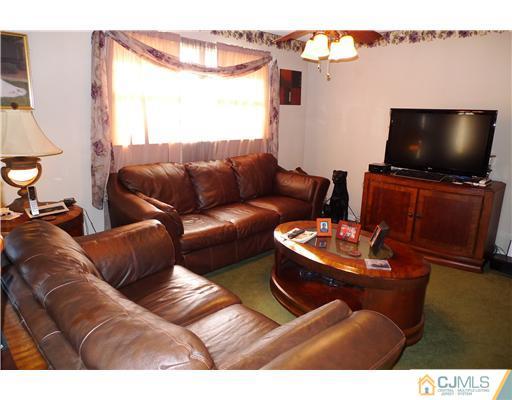 4 Halstead Road New Brunswick, NJ 08901 - Photo 2 of 17 a living room with furniture and a flat screen tv