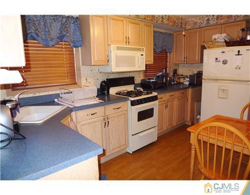 4 Halstead Road New Brunswick, NJ 08901 - Photo 4 of 17 a kitchen with a sink stove and refrigerator