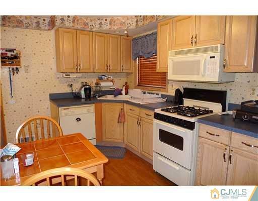 4 Halstead Road New Brunswick, NJ 08901 - Photo 5 of 17 a kitchen with a sink a stove and cabinets