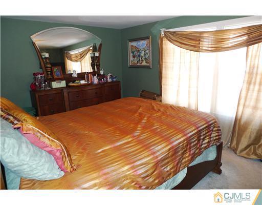4 Halstead Road New Brunswick, NJ 08901 - Photo 7 of 17 a bed sitting in a bedroom next to a window