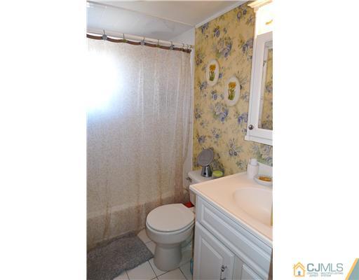 4 Halstead Road New Brunswick, NJ 08901 - Photo 10 of 17 a bathroom with a sink a toilet and shower curtain
