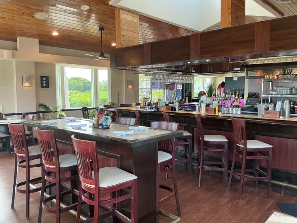 a kitchen with a large dining table and chairs