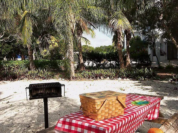 a backyard of a house with table and chairs