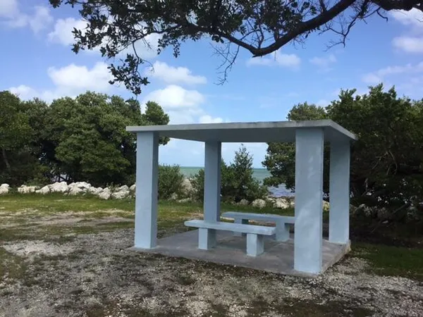 a view of a fountain in front of a house with a big yard