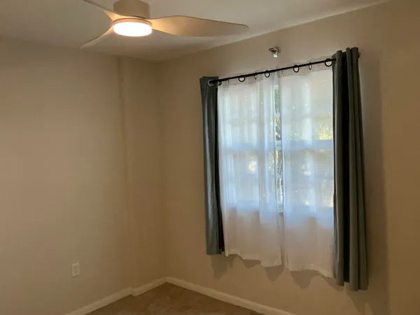 a bathroom with a glass shower door and mirror