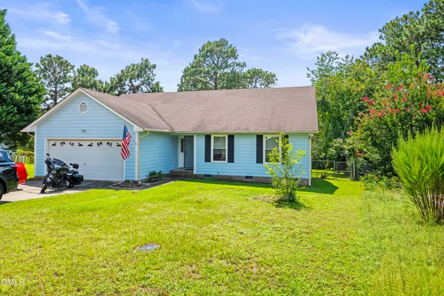 a view of a house with pool and a yard