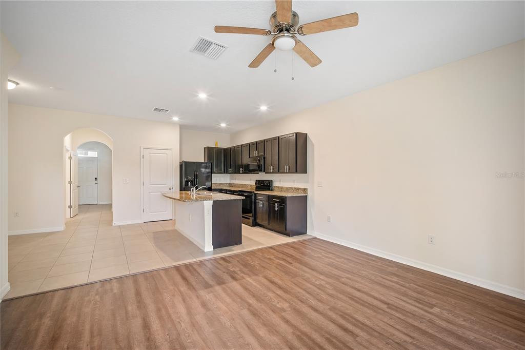 8619 Falling Blue Place Riverview, FL 33578 - Photo 13 of 27 a kitchen with stainless steel appliances kitchen island a sink and a refrigerator