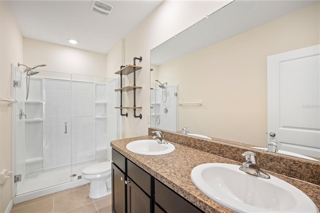 8619 Falling Blue Place Riverview, FL 33578 - Photo 16 of 27 a bathroom with a granite countertop sink toilet a shower and a mirror