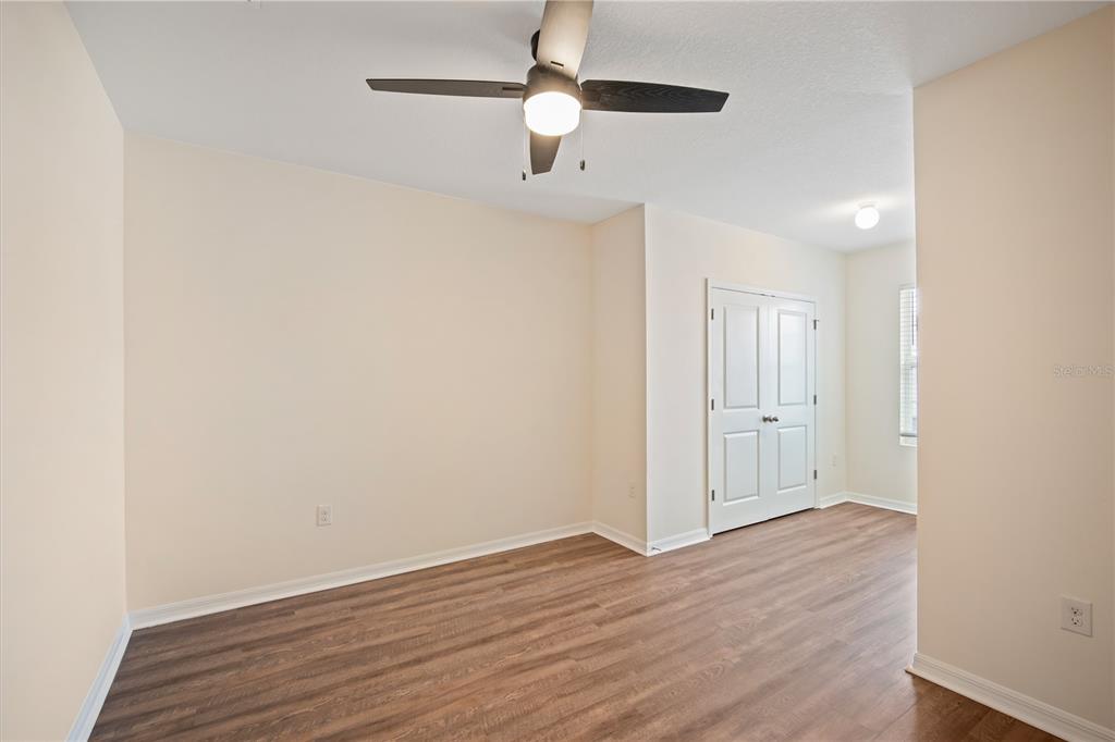 8619 Falling Blue Place Riverview, FL 33578 - Photo 19 of 27 a view of an empty room with wooden floor
