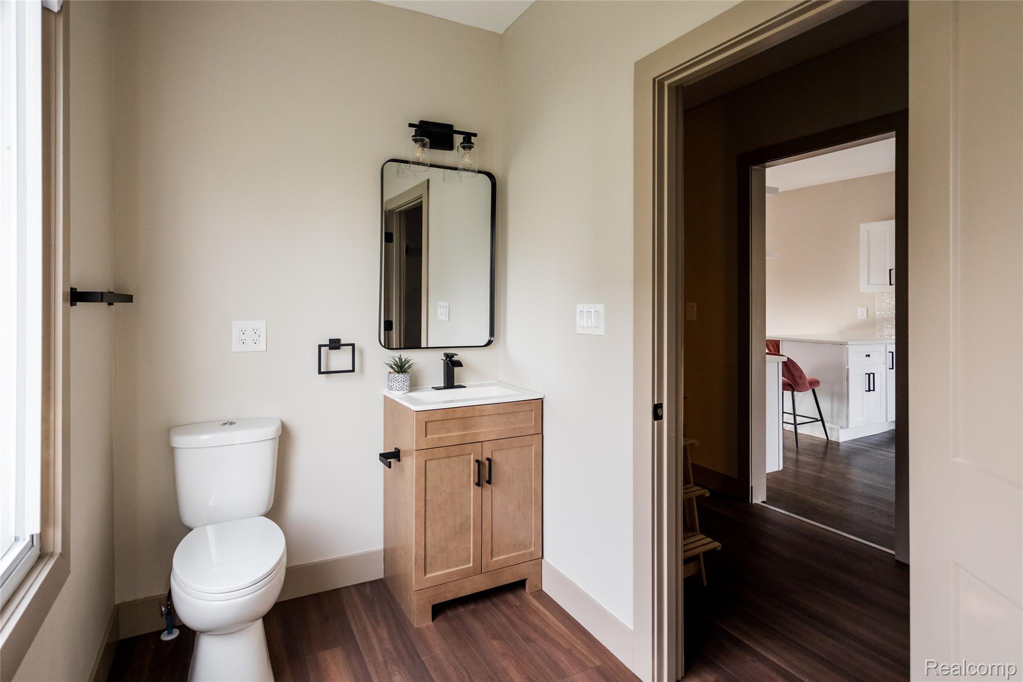 2630 Harding Street Detroit, MI 48214 - Photo 15 of 30 Bathroom with a light wood-finish vanity, white countertop, and dark-finish hardware