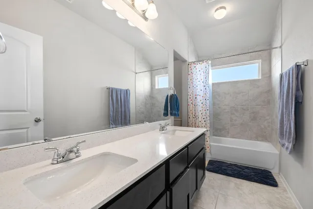 a bathroom with a sink a toilet a large mirror and shower