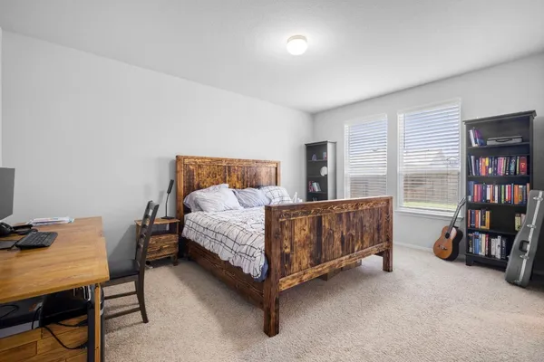 a bedroom with a bed and a book shelf