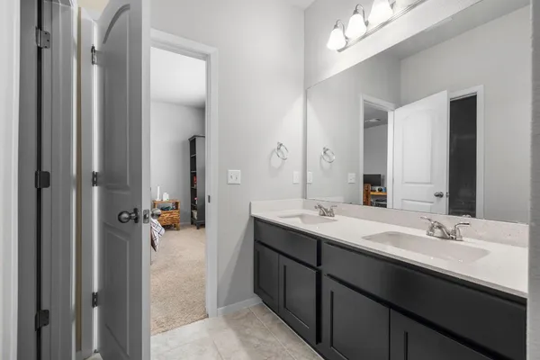 a en suite bathroom with a double vanity sink double and mirror