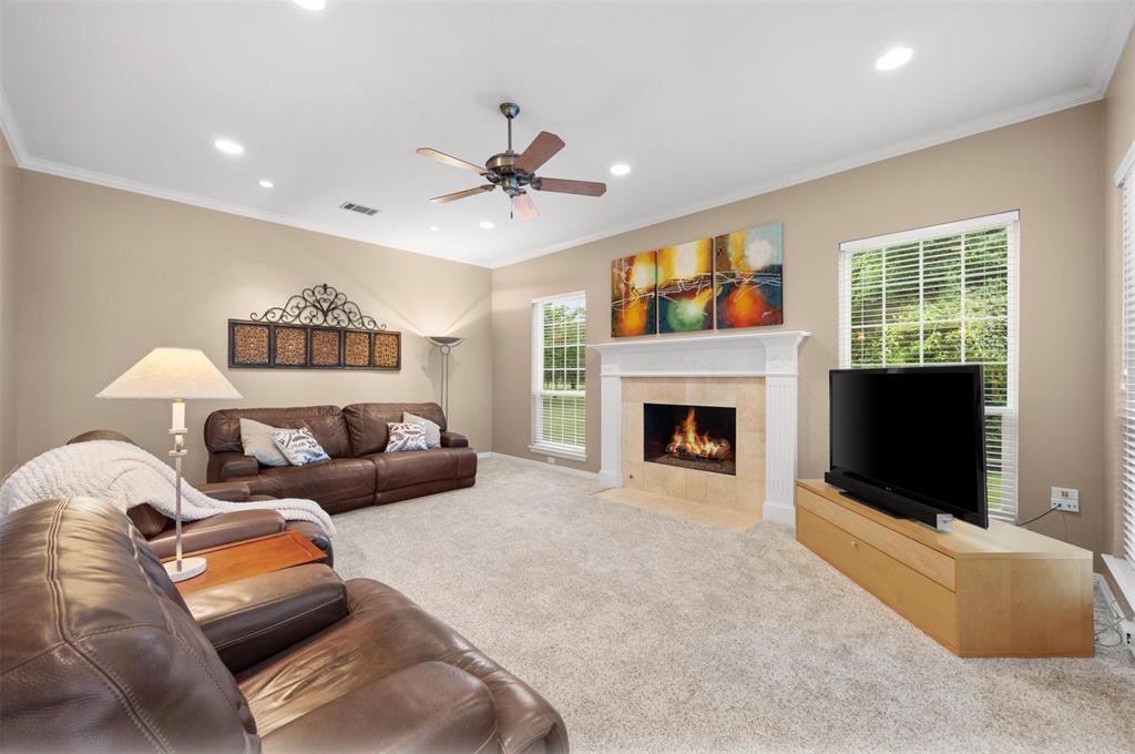 506 Meadowview Road Heath, TX 75032 - Photo 17 of 32 a bedroom with furniture and a fireplace