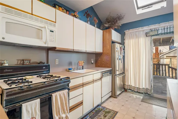 a kitchen with stainless steel appliances granite countertop a stove and a refrigerator