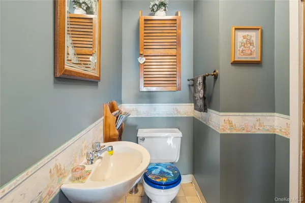 a bathroom with a sink a toilet and a window