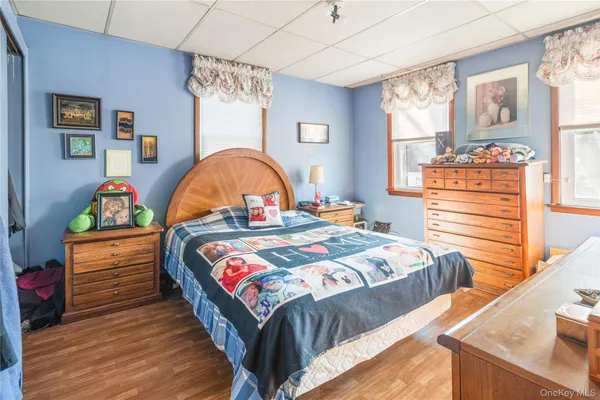 a bedroom with bed and wooden floor