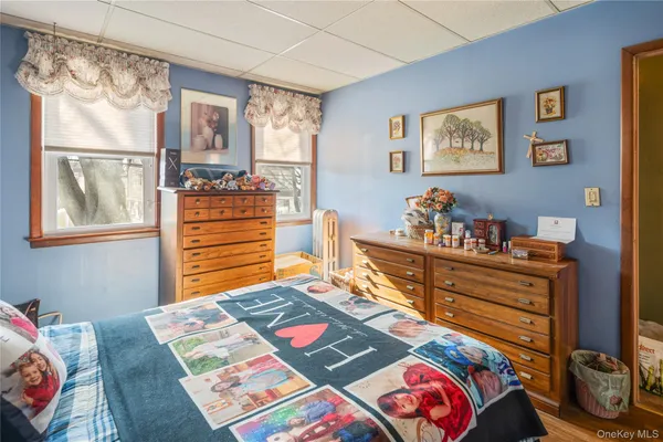 a bed sitting in a bedroom next to a window