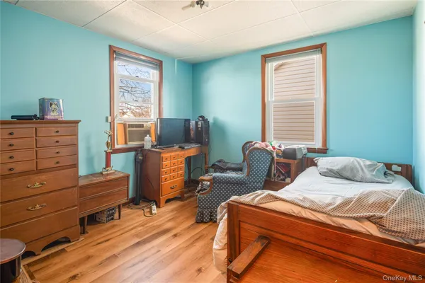 a bedroom with a bed and a bookshelf