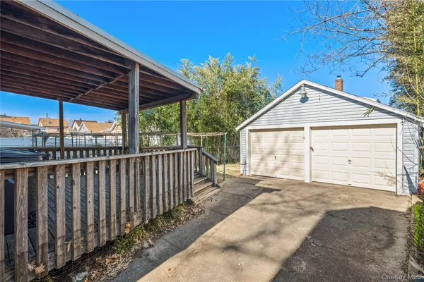 a view of backyard with small cabin and wooden fencing