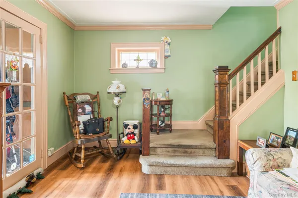 a view of entryway and hall with wooden floor