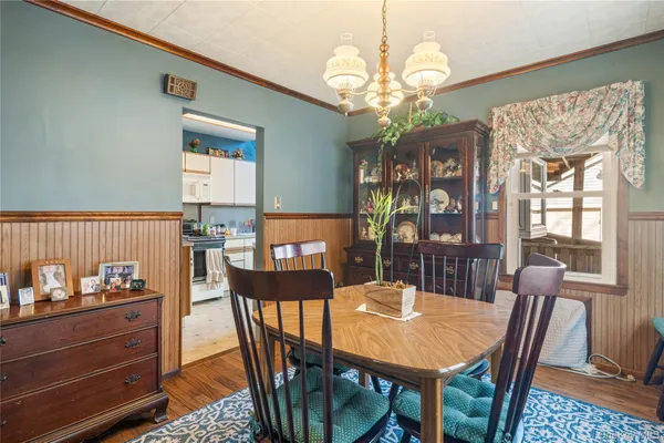 a view of a dining room with furniture and chandelier
