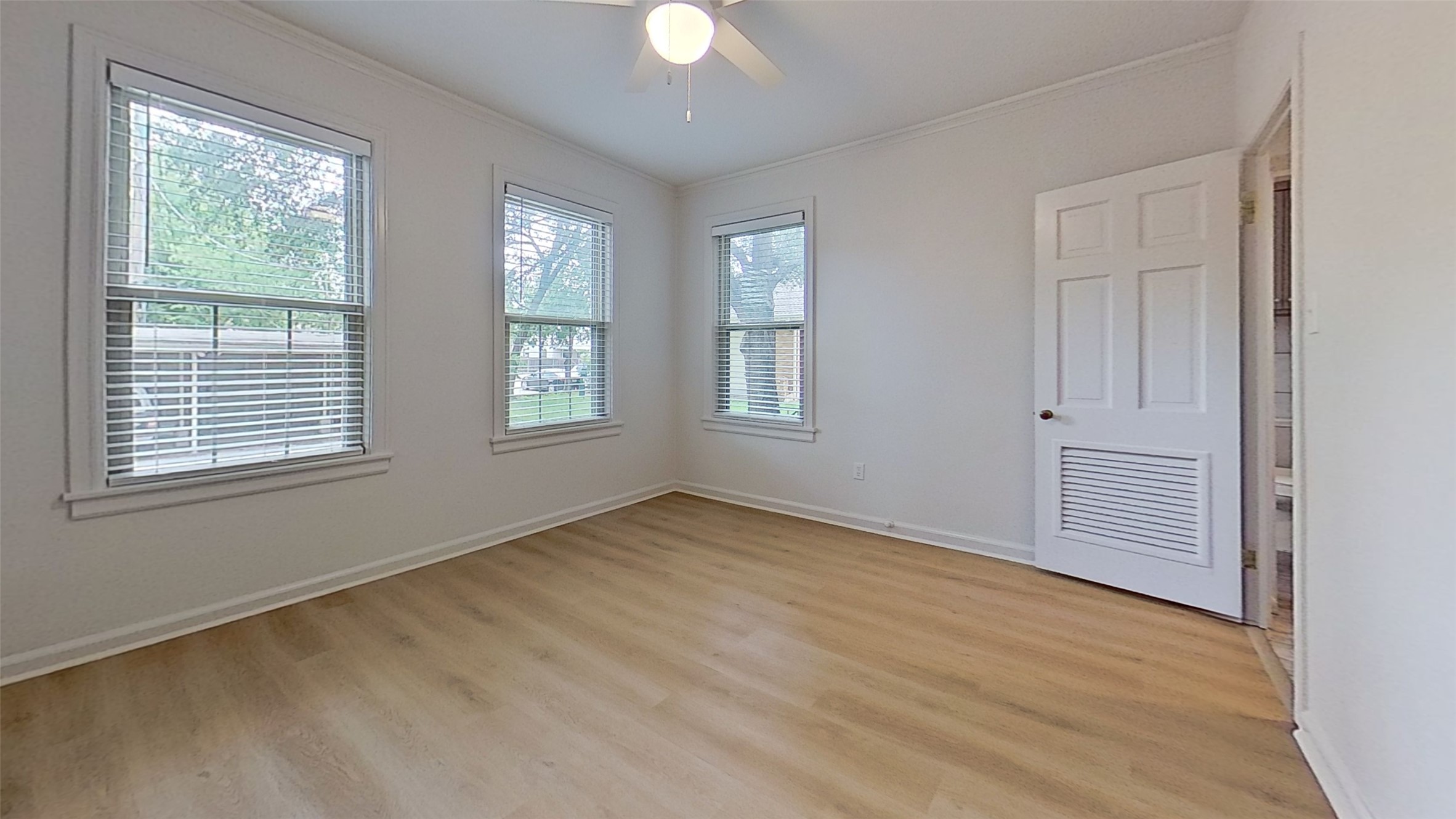 1703 Summit View Place, Unit A Austin, TX 78703 - Photo 9 of 13 Natural light filters through ample windows, illuminating this inviting space with warm, wood-look flooring.