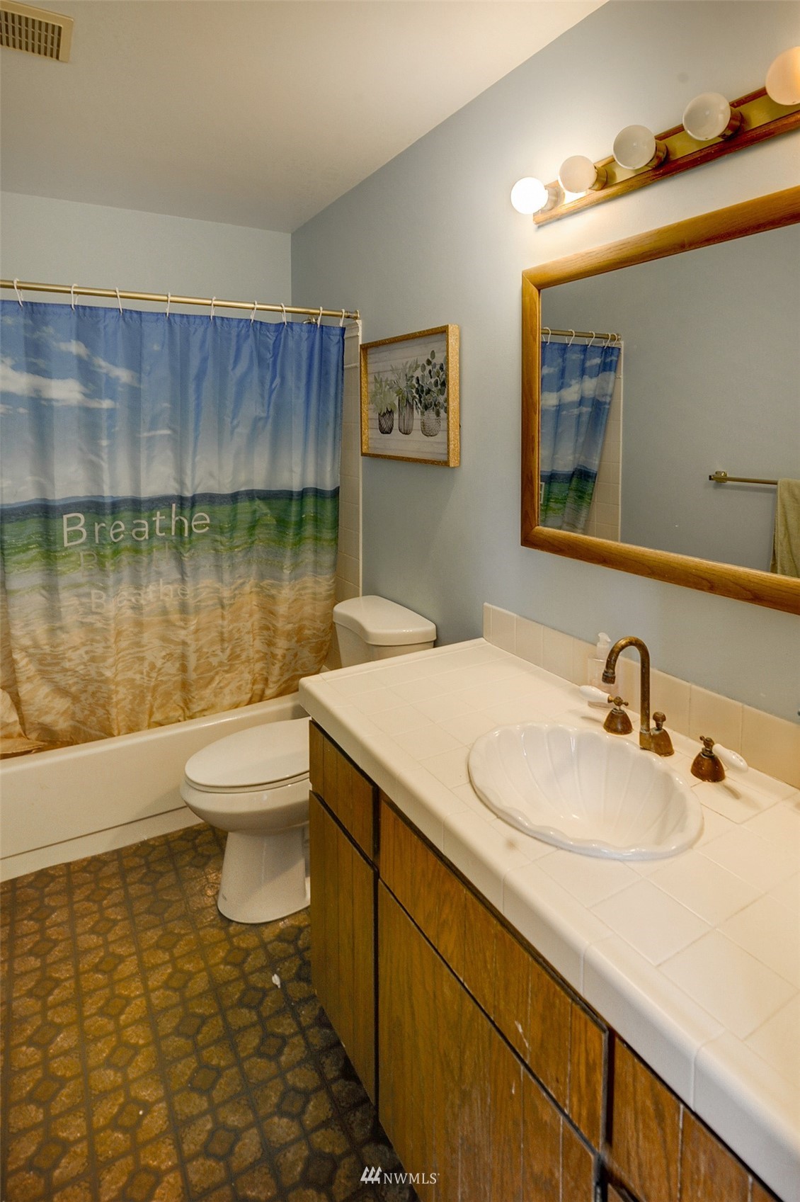 20414 West Richmond Road Bothell, WA 98021 - Photo 22 of 30 a bathroom with a sink a toilet and a mirror