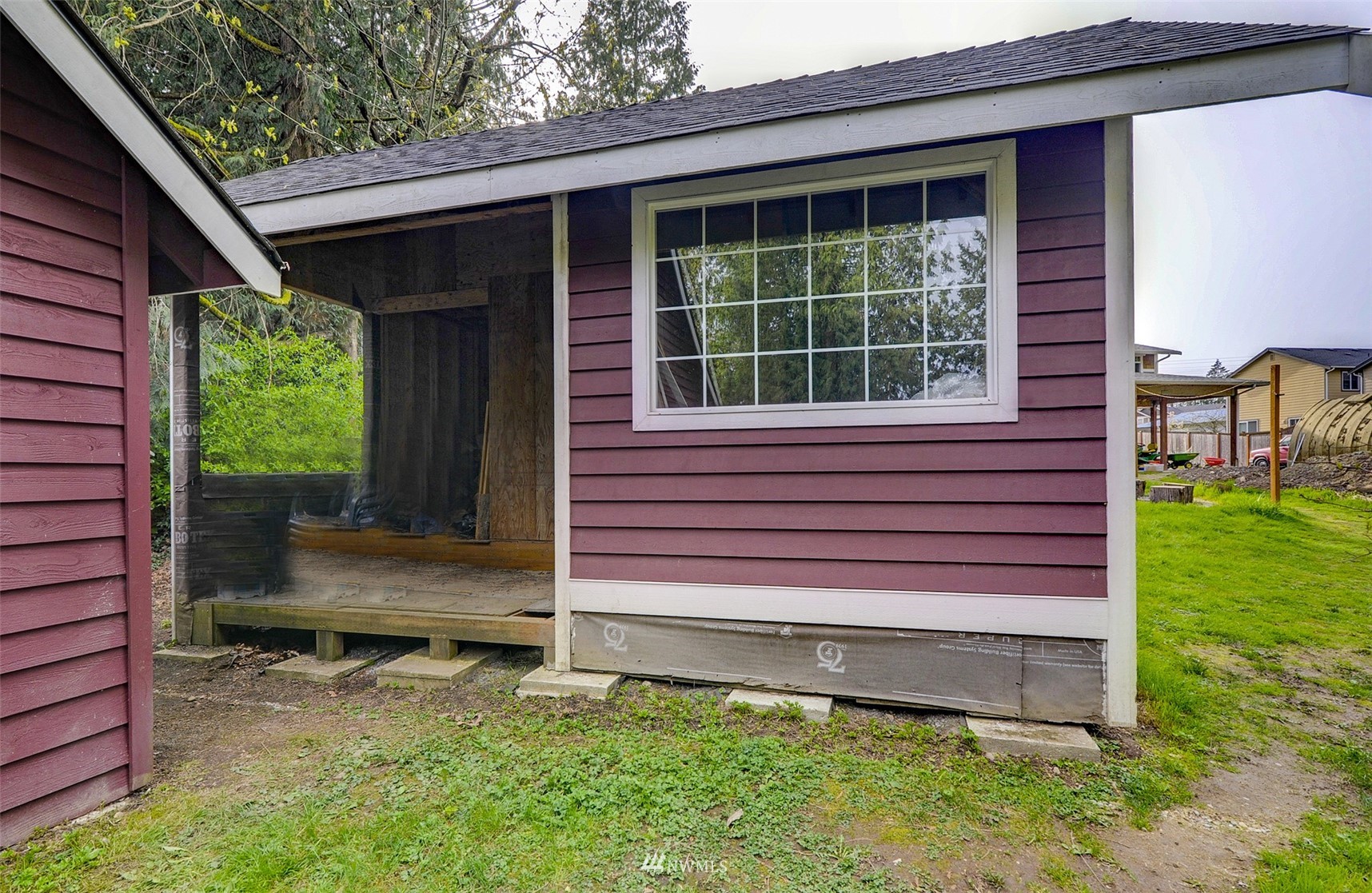 20414 West Richmond Road Bothell, WA 98021 - Photo 25 of 30 a wooden bench sitting in front of a house