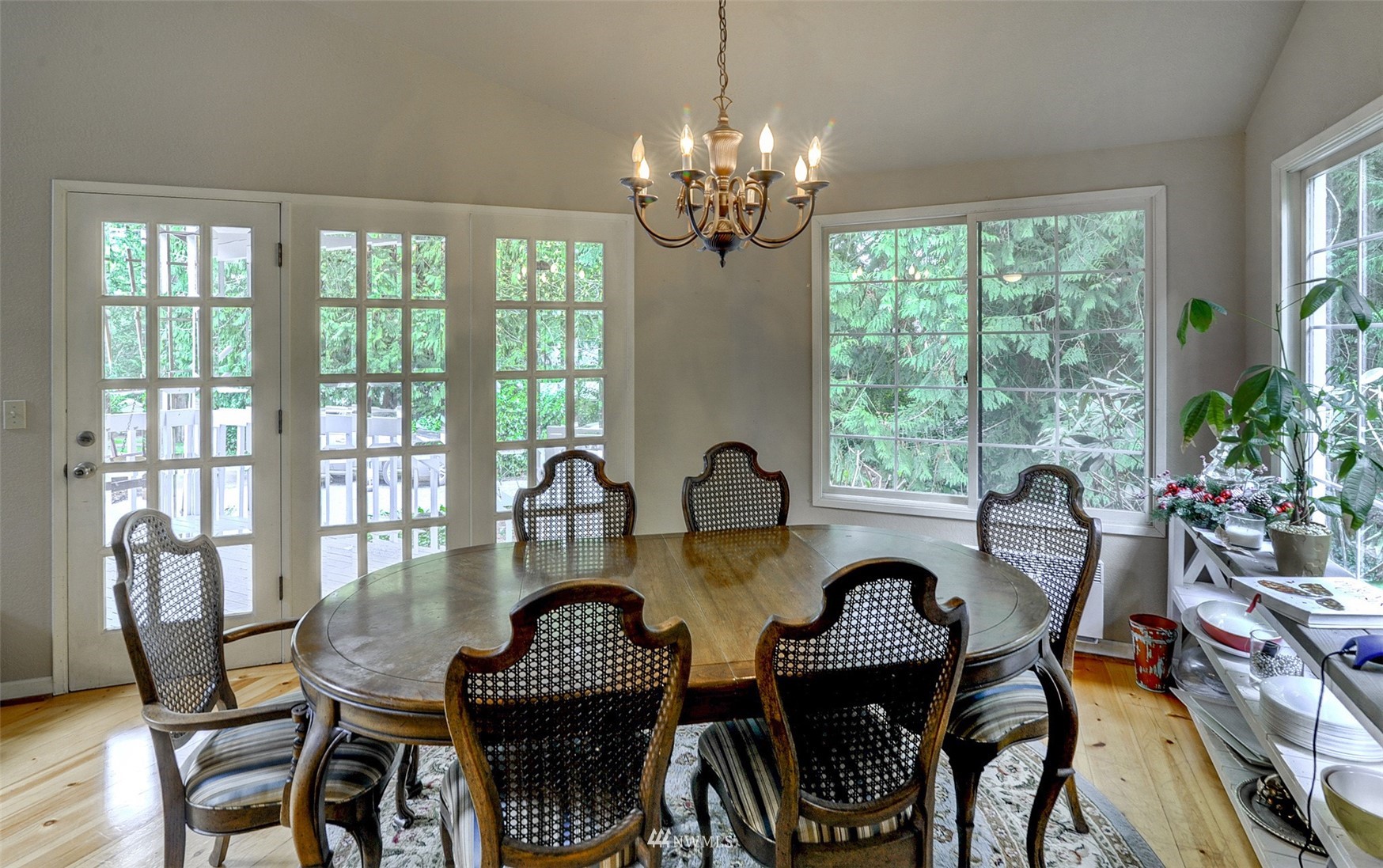 20414 West Richmond Road Bothell, WA 98021 - Photo 8 of 30 a dining room with furniture a chandelier and wooden floor