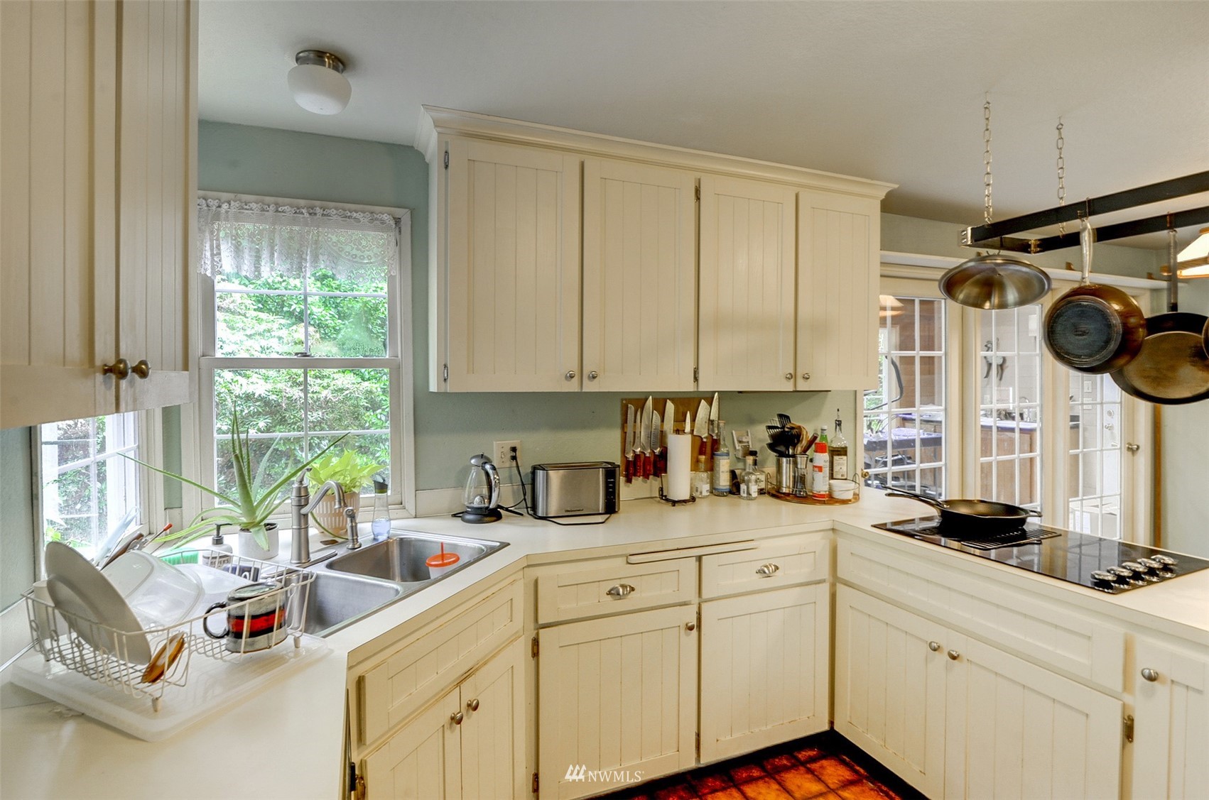 20414 West Richmond Road Bothell, WA 98021 - Photo 10 of 30 a kitchen with white cabinets and window