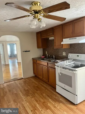 a kitchen with a stove cabinets and a sink