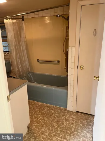 a bathroom with a shower and a bath tub