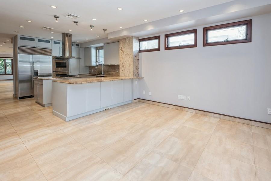 211 81st Street Brooklyn, NY 11209 - Photo 12 of 35 a large kitchen with stainless steel appliances kitchen island a large counter top and a refrigerator