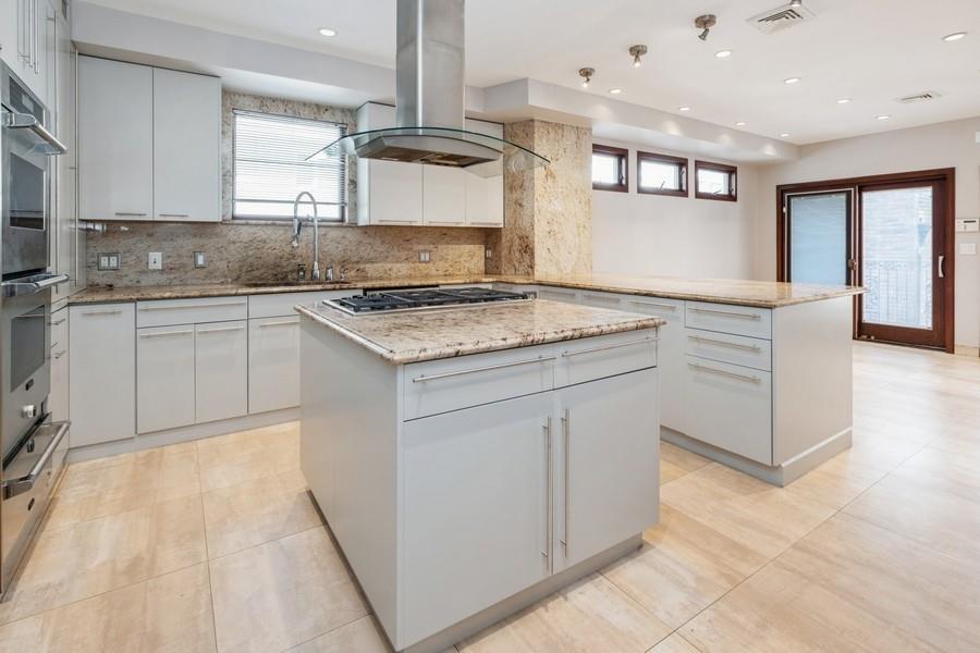 211 81st Street Brooklyn, NY 11209 - Photo 13 of 35 a kitchen with stainless steel appliances granite countertop a sink and a stove