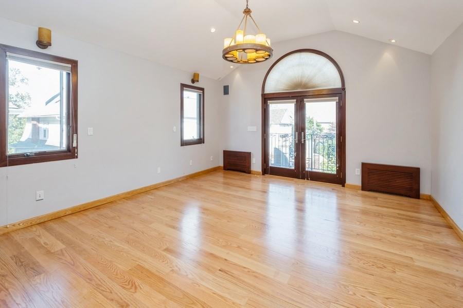 211 81st Street Brooklyn, NY 11209 - Photo 17 of 35 a view of an empty room with window and wooden floor