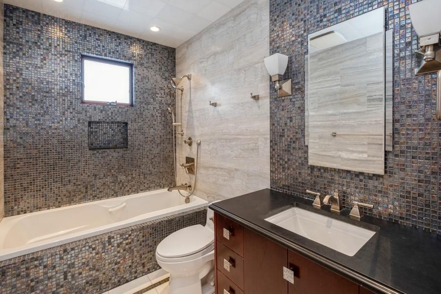 211 81st Street Brooklyn, NY 11209 - Photo 19 of 35 a bathroom with a sink a toilet a bathtub and shower